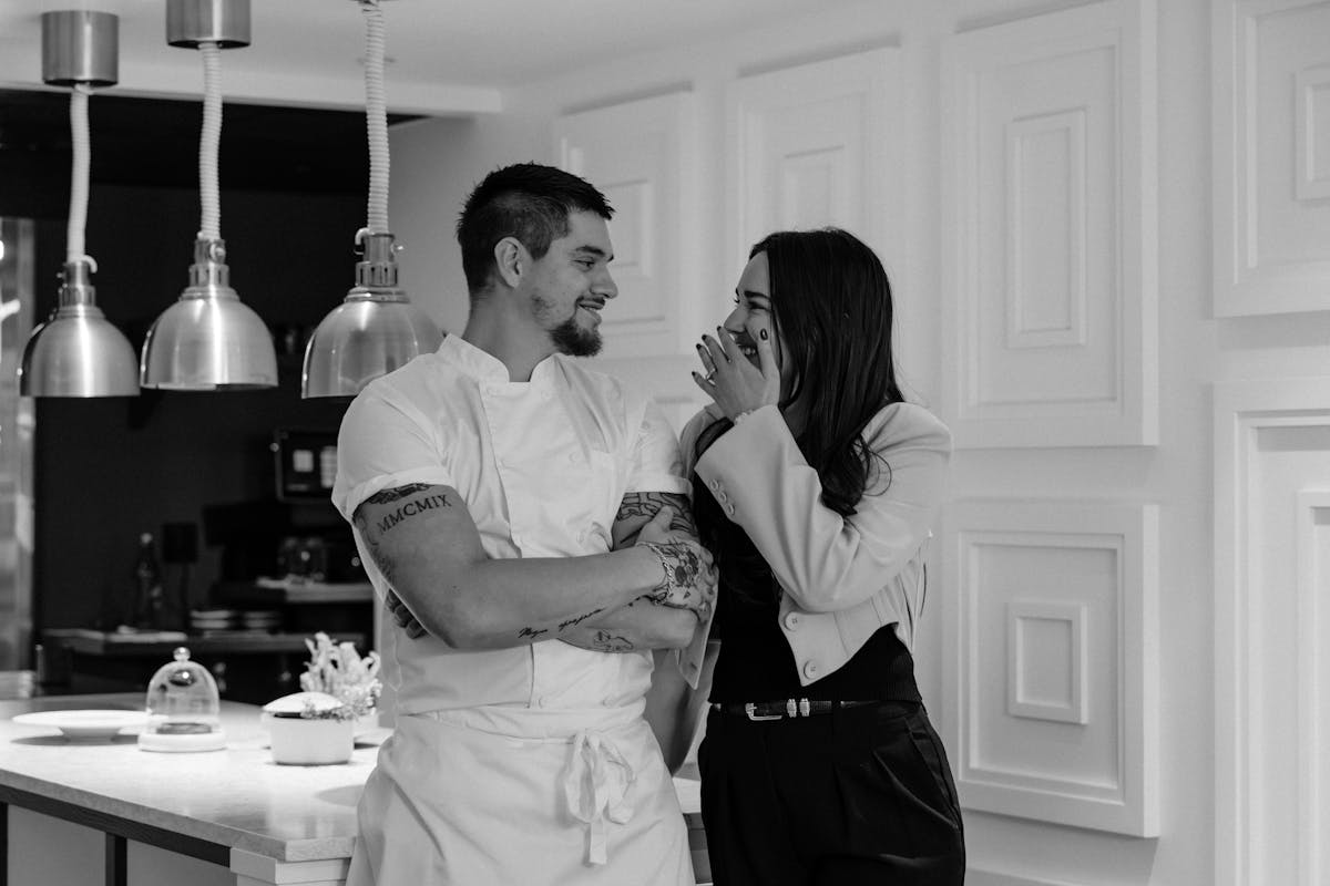 a man and a woman standing in a kitchen